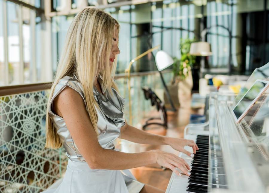 Piano bar entertainer performing for guests in a lounge
