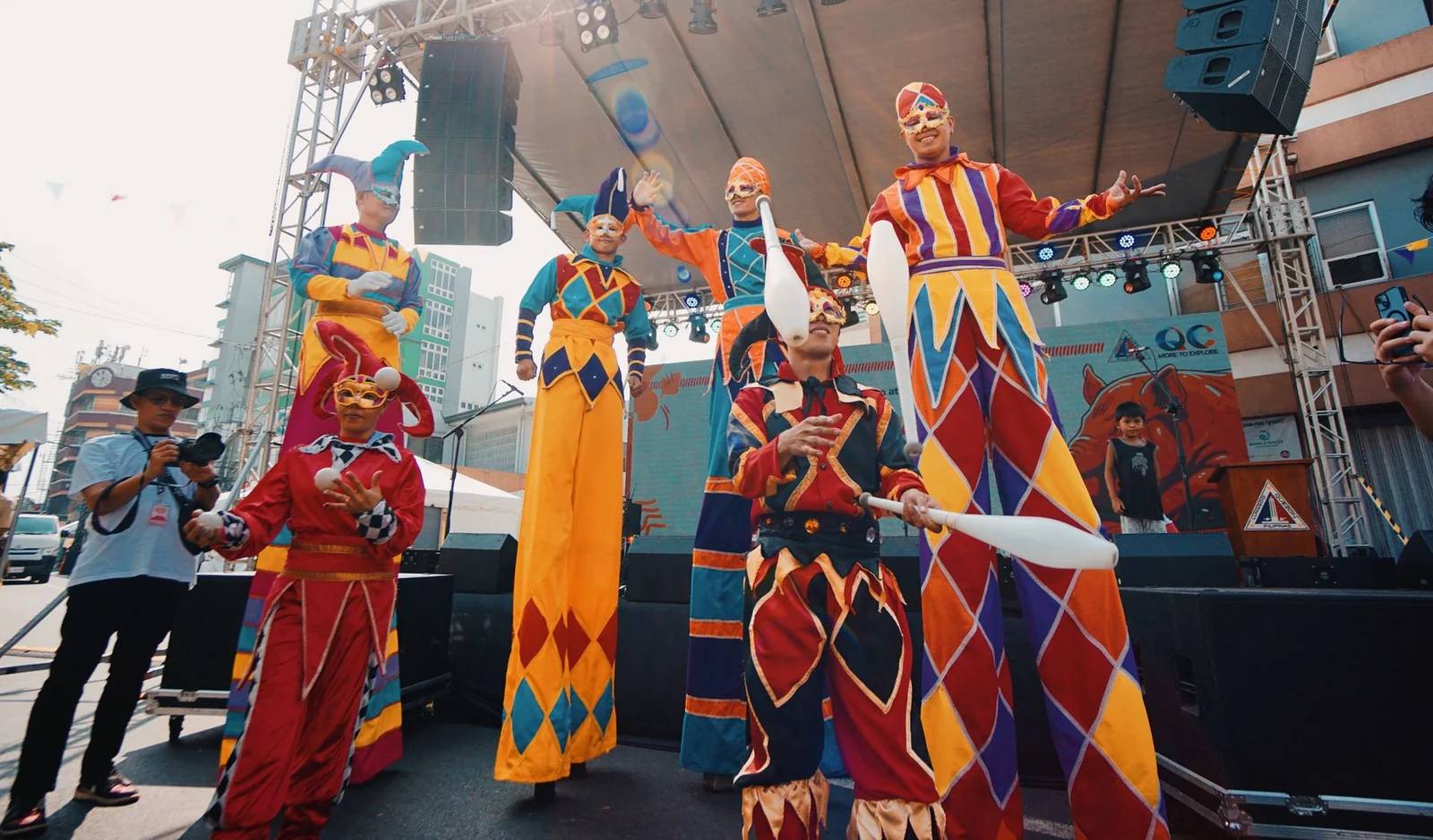 Stilt walkers performing on an outdoor entertainment stage - Rising Stars