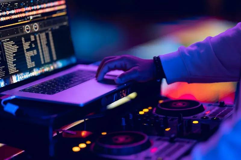 DJ mixing on controller and laptop